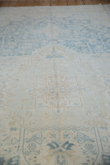 Distressed texture of powder blue and ivory Heriz carpet, showing foundation wear.
