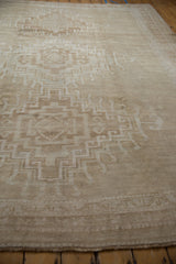 Distressed Oushak carpet showing subtle abrashes, stepped medallion, and hook and latch motifs.