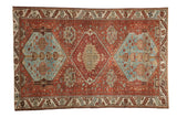 Distressed vintage Hamadan rug featuring a triple geometric medallion in chestnut and dusty blue.