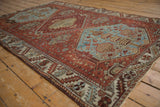 Distressed texture on the dusty denim blue medallion with geometric floral motifs of vintage Hamadan rug.