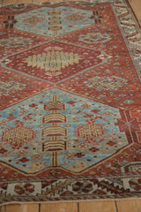 Distressed vintage Hamadan rug with geometric floral lattice and visible chestnut denim blue wear.
