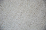 Hand-woven ivory flatweave texture with subtle speckled character on vintage Turkish rug.
