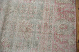 Distressed Sparta carpet detail highlighting wear to foundation and knot heads, pink florals.