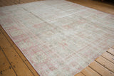 Distressed vintage Sparta carpet with faded pale pink and grey floral motifs.