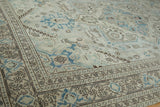 Distressed vintage Sparta rug detail with geometric border and pale blue palmette pattern.