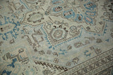Distressed ivory field with faded denim blue geometric buds and chocolate brown outlines.