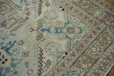 Geometric patterns and distressed texture of vintage Turkish Sparta rug in blue, ivory, brown.