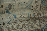 Distressed pile texture of the Sparta carpet, ivory, blue, and brown geometric motifs.