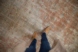 Distressed vintage Sparta carpet showing faded floral motifs and delicate vinery in muted sandalwood and silver.