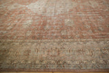 Detail of the distressed hand-knotted Turkish Sparta carpet, featuring faded sandalwood florals and geometric border.