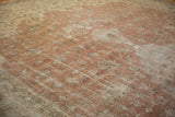 Distressed vintage Sparta carpet showing faded sandalwood field, ivory floral motifs, and visible foundation wear.