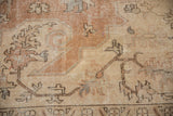 Distressed Turkish Sparta carpet close-up, featuring worn beige pile and delicate vinery patterns.