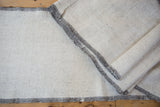Hand-woven construction and charcoal side cord selvage of a vintage Turkish flatweave runner.