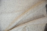 Hand-spun flatweave texture with ivory and charcoal speckled character.
