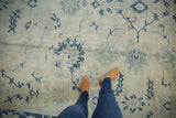 Overhead view showing the even wear and low pile texture of a distressed Oushak carpet.