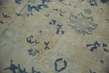 Even wear to the knot heads on a distressed Turkish Oushak with dusty navy and sea foam green motifs.