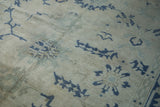 Even wear down to the knot heads on a distressed Oushak with dusty blue geometric patterns.