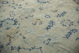Hand-knotted pile of a distressed Oushak showing even wear and navy geometric designs.