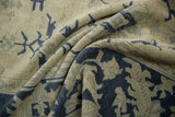 Folded vintage Oushak carpet revealing the texture of evenly worn knot heads.