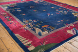 Vintage Chinese Art Deco carpet corner: navy field, cochineal red border with pagoda landscape.
