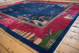 Nichols Art Deco carpet: cochineal red border, green pictorial design, navy edge.