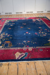 Pictorial Art Deco carpet detail: navy field, cochineal red border, lotus flowers, white knots.