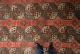 Distressed Ersari carpet detail: dusty red, oxidized silver, ivory geometric guls.