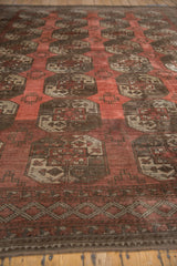 Vintage Ersari carpet with repeating geometric guls in dusty red and time-softened tones.