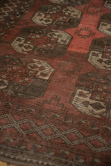 Distressed vintage Ersari carpet with oversize floral guls in dusty chestnut and wine red.