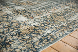 Vintage distressed Sparta carpet with faded floral motifs, worn pile, and exposed foundation.