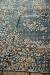 Distressed Sparta rug showing mostly even wear, exposed foundation, and floral sprays.