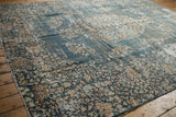 Distressed vintage Sparta carpet with faded denim blue and ivory floral sprays.