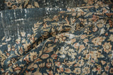 Distressed texture of vintage Sparta carpet, revealing worn denim blue pile and pale gold floral pattern.