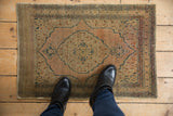 Vintage Tabriz rug with central terracotta medallion, nuanced abrash, and even pile wear.