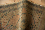 Vintage Tabriz rug fold showing book cover style spandrel, even wear, and nuanced abrash.