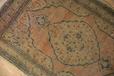 Vintage Tabriz rug spandrel with muted peach, beige, and dusty blue, showing abrash and even wear.
