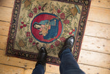 Antique Isfahan pictorial rug mat shown in place to illustrate its small, square scale.