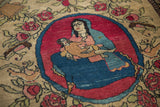 Hand-knotted detail of a mother and child pictorial motif within a cochineal red medallion.