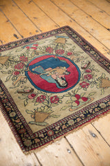 The unique pictorial design of an antique Isfahan rug, presented at an angle on flooring.