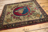 An antique pictorial Isfahan rug with a central medallion, seen from a high corner angle.