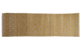 Distressed vintage Khotan runner with repeating floral panels, saffron yellow, beige, and visible abrashes.