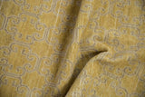 Folded texture of vintage Khotan runner, showcasing distressed gold and beige floral panel motif.