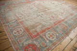 Low pile texture on vintage Oushak carpet, highlighting powder blue border and terra cotta motifs.
