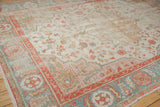 Vintage Oushak carpet corner with powder blue, terra cotta borders, floral motifs, and wear.