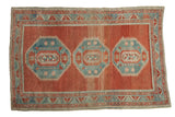 Distressed vintage Caucasian rug with triple blue medallion, cinnabar red abrashed field, 4'9