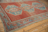 Distressed geometric medallion, germinating plants, and abrashed field of Caucasian rug.