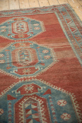 Abrashed cinnabar red pile, powder blue geometric medallion, showing even wear.