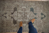 Distressed vintage Hamadan rug showcasing its aged texture, oxidized silver and muted blue pattern.