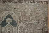 Distressed vintage Hamadan rug detail with dusty pale navy blue geometric spandrel and visible wear.