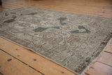 Distressed vintage Hamadan rug detail, showing muted geometric motifs and intact selvage.